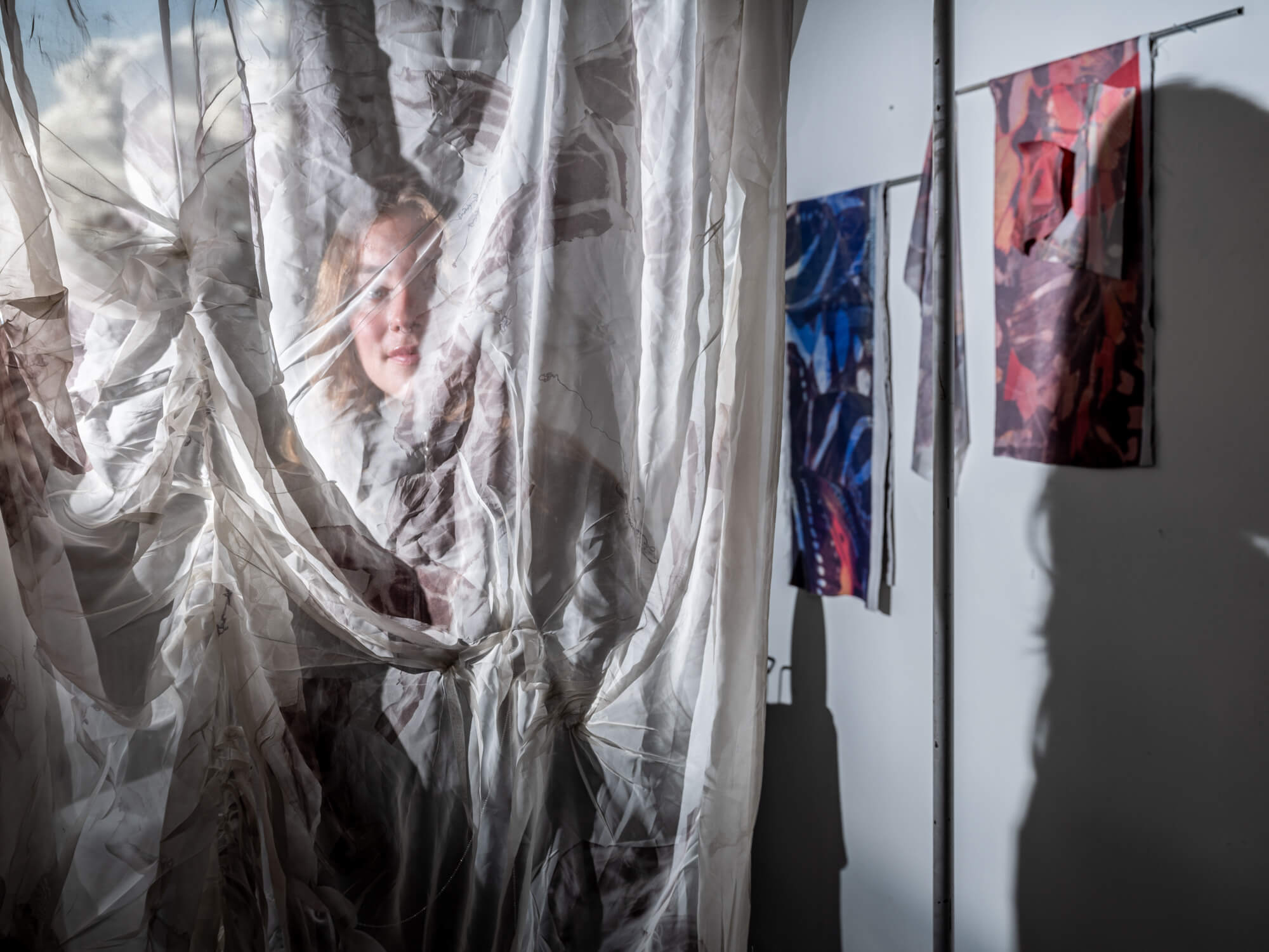 Woman looking through sheet